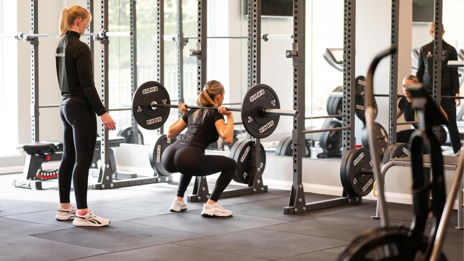 The Culloden Estate And Spa Holywood  Bagian luar foto A woman performing a back squat with a barbell